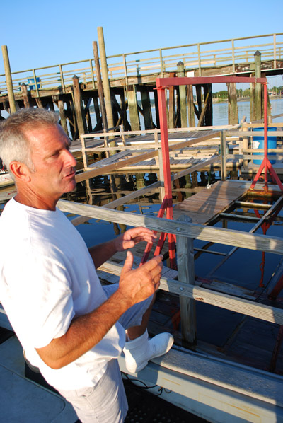 Bill Painter of the North Oyster Bay Baymen's Association inspects what's left of the system used to incubate the public's annual crop of clam and oyster seeds. (Photo by: Christopher Twarowski/Long Island Press)