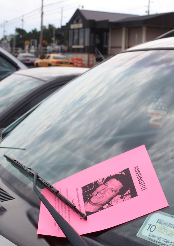 A missing person flyer tucked onto the windshield of a car at the Long Island Rail Road Deer Park Station, where his bright red 2004 Pontiac GTO was found. (Photo credit: Bob Savage)