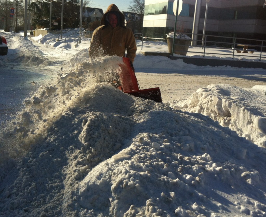 A snow thrower operator clears a sidewalk in East Garden City on Wednesday, Jan. 22, 2013.