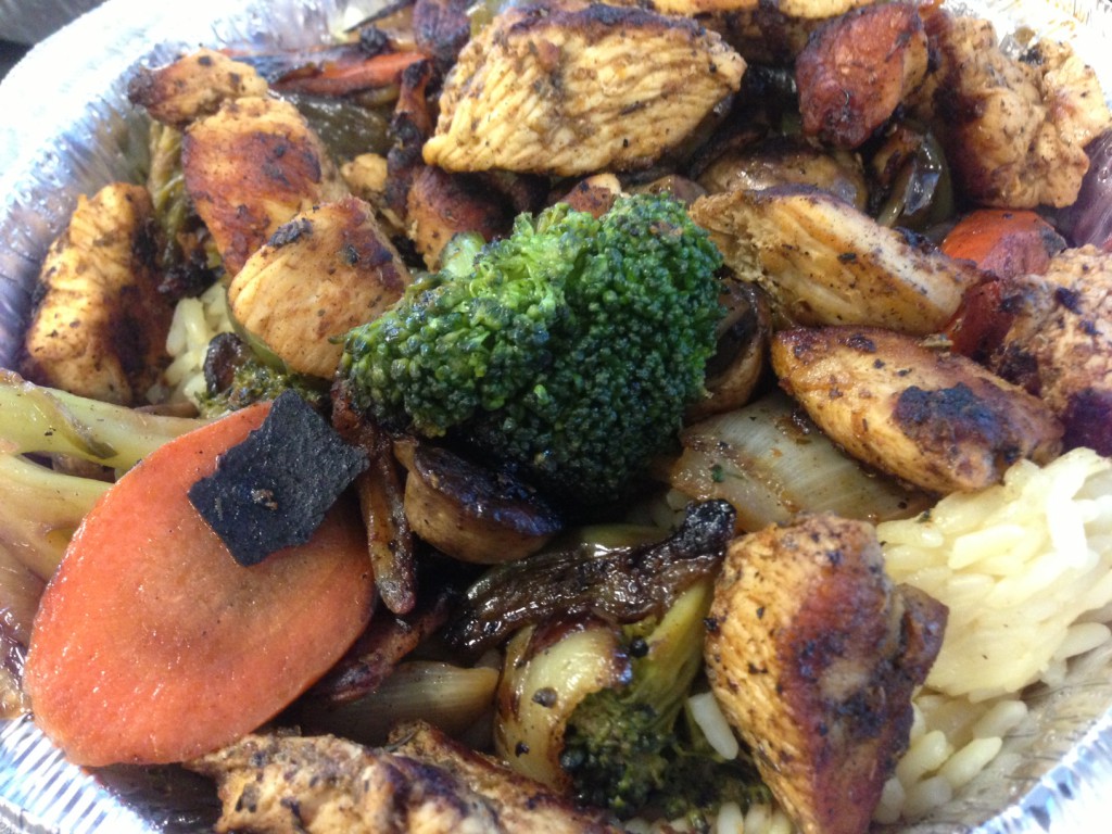 Thick, juicy chunks of chicken souvlaki atop heaping mounds of fresh onions, broccoli, carrots, mushrooms, peppers and rice is what you'll find at It's Greek To Me restaurant in Syosset. (Chris Cooke/Long Island Press)