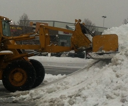 Plows attacking the snow during a previous storm.