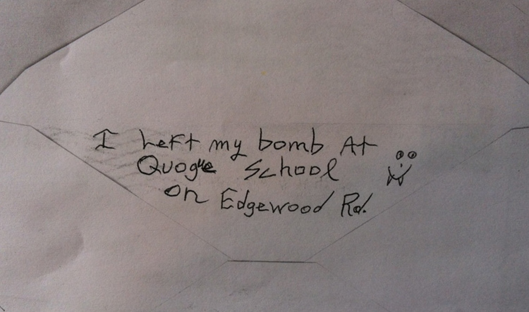 The above bomb threat against Quogue School was mailed to the Long Island Press in March 2013. A similar threat against Islip Town Hall exhibiting similar handwriting and other characteristics was received by the Press May 13, 2014. (Christopher Twarowski/Long Island Press)