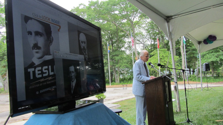 William Turbo, Tesla’s grandnephew, is the distinguished silver-haired gentleman at the podium. (Spencer Rumsey/Long Island Press)