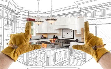 Male Contractor Hands Framing Completed Section of Custom Kitchen Design Drawing