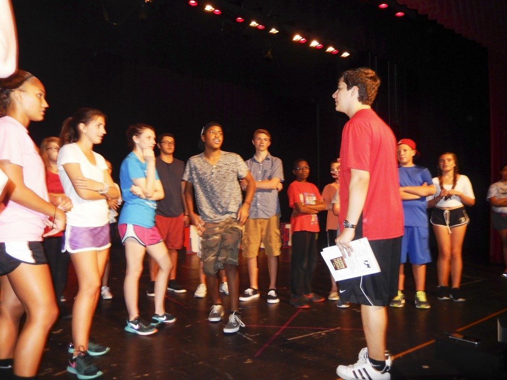 Director Tom Vestuto leads students.