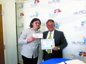 Ryan Harvey, a ninth-grader at The Village School, is presented with a $3,000 check and first place certificate for his essay by Peter Klein, president of The Claire Friedlander Family Foundation.