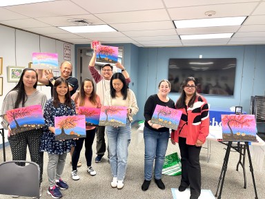 Painters pose with their canvases at Madhumita Sen's November class at the Jericho library