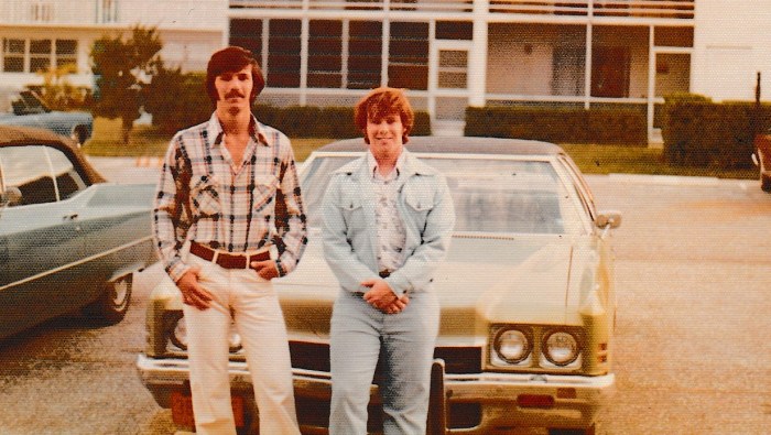 Westbury friends in front of a car.