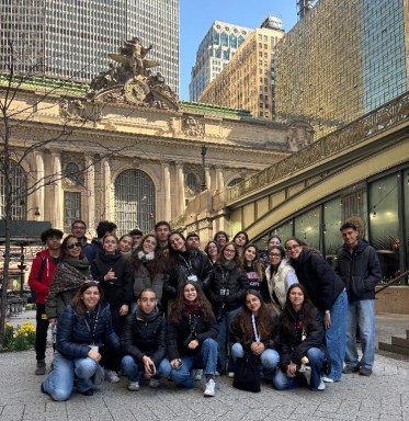 Mineola students and Portuguese students sit together outside Grand Central