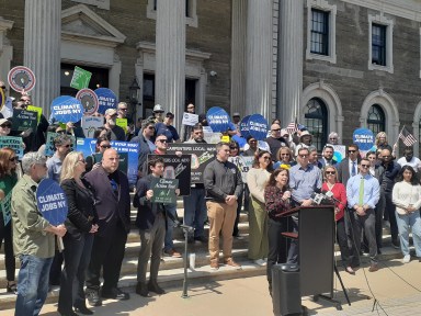 Union workers and environmental advocates gathered on the steps of the Nassau County Legislature in Mineola on April 22 to demand offshore wind projects continue.