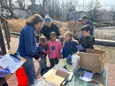 Volunteers helping to clean up the tributaries that feed into Manhasset Bay.