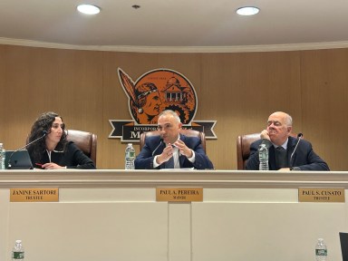 Mineola's Board of Trustees sits and speaks at their Wednesday meeting.