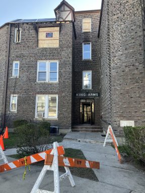 Floral Park building that caught fire with boards on window.