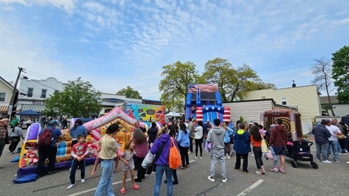 The "kids area" at Oyster Bay Day features a variety of inflatables and games