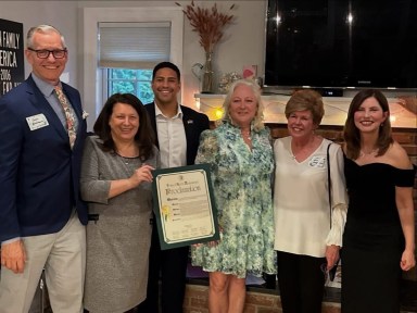 Public officials including Town of North Hempstead Council Member Mariann Dalimonte and Baxter Estates Mayor Nora Haagenson honored community leader Holly Byrne at the Baxter's Pond Foundation progressive dinner in early April.