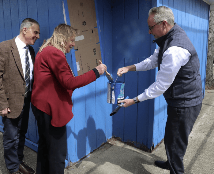 Town of Hempstead Supervisor Donald Clavin painting over a swastika.