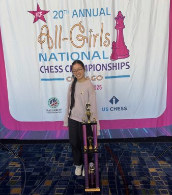 Leah Yang, an eighth grader from Jericho Middle School, stands with her second place trophy at the All-Girls National Chess Championships in Chicago