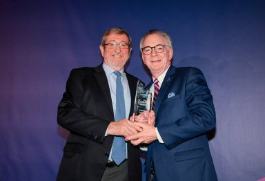 Dr. John Procaccino (R.) receiving the "Truly Caring Touch" award from Northwell Health President and CEO Michael Dowling (L.).
