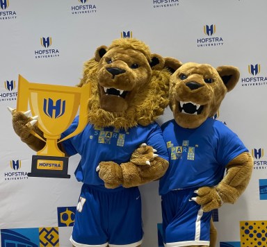 Hofstra University's mascots, Kate and Willie Pride, pose with the school's new logo ahead of it's centennial celebration.