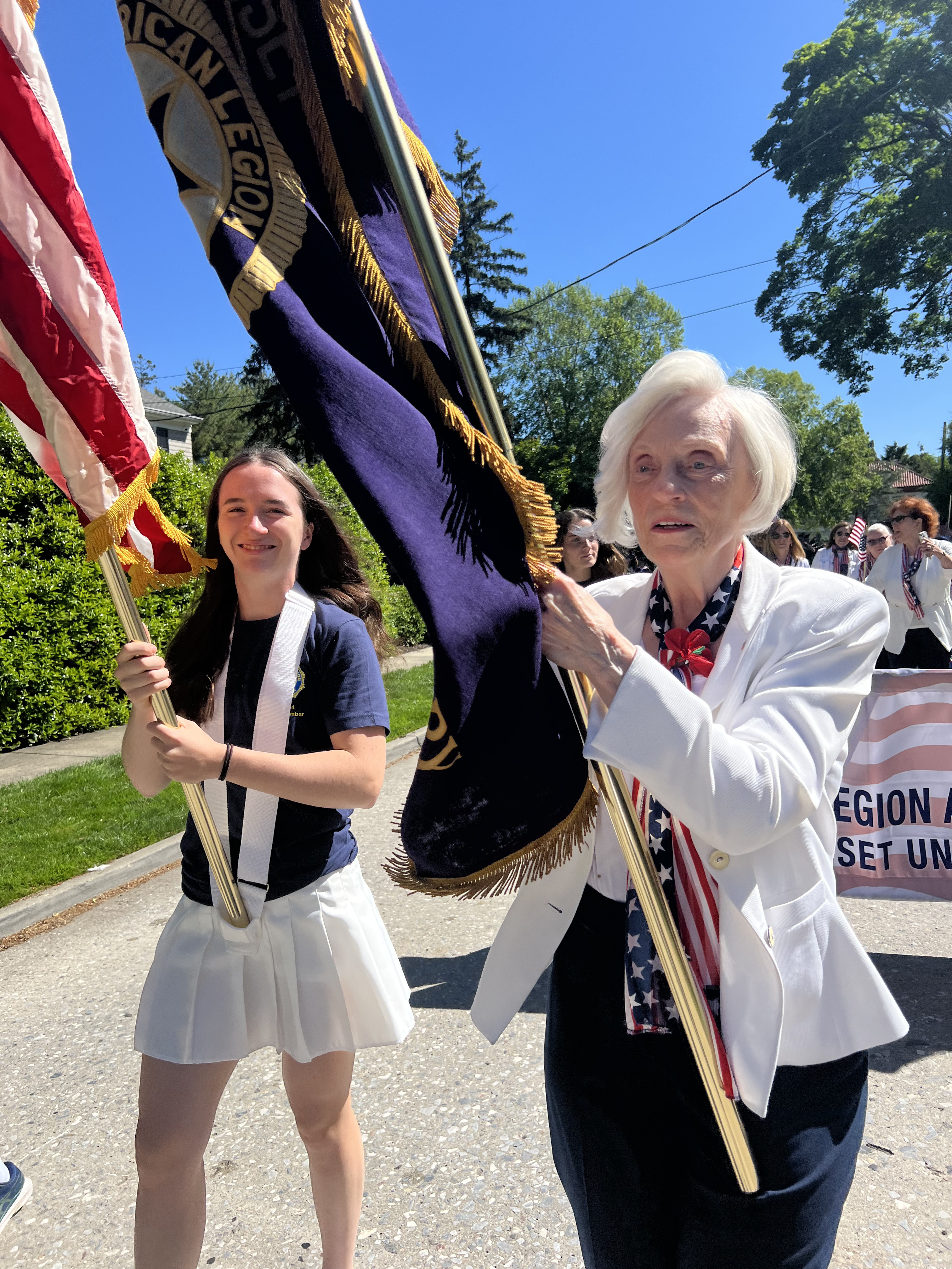 Manhasset American Legion Auxiliary members carry flags in the Memorial Day parade.