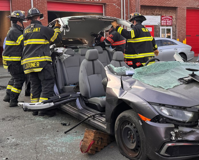 Members of the Great Neck Vigilant Fire Company remove a car's roof during a rescue training event in Port Washington.