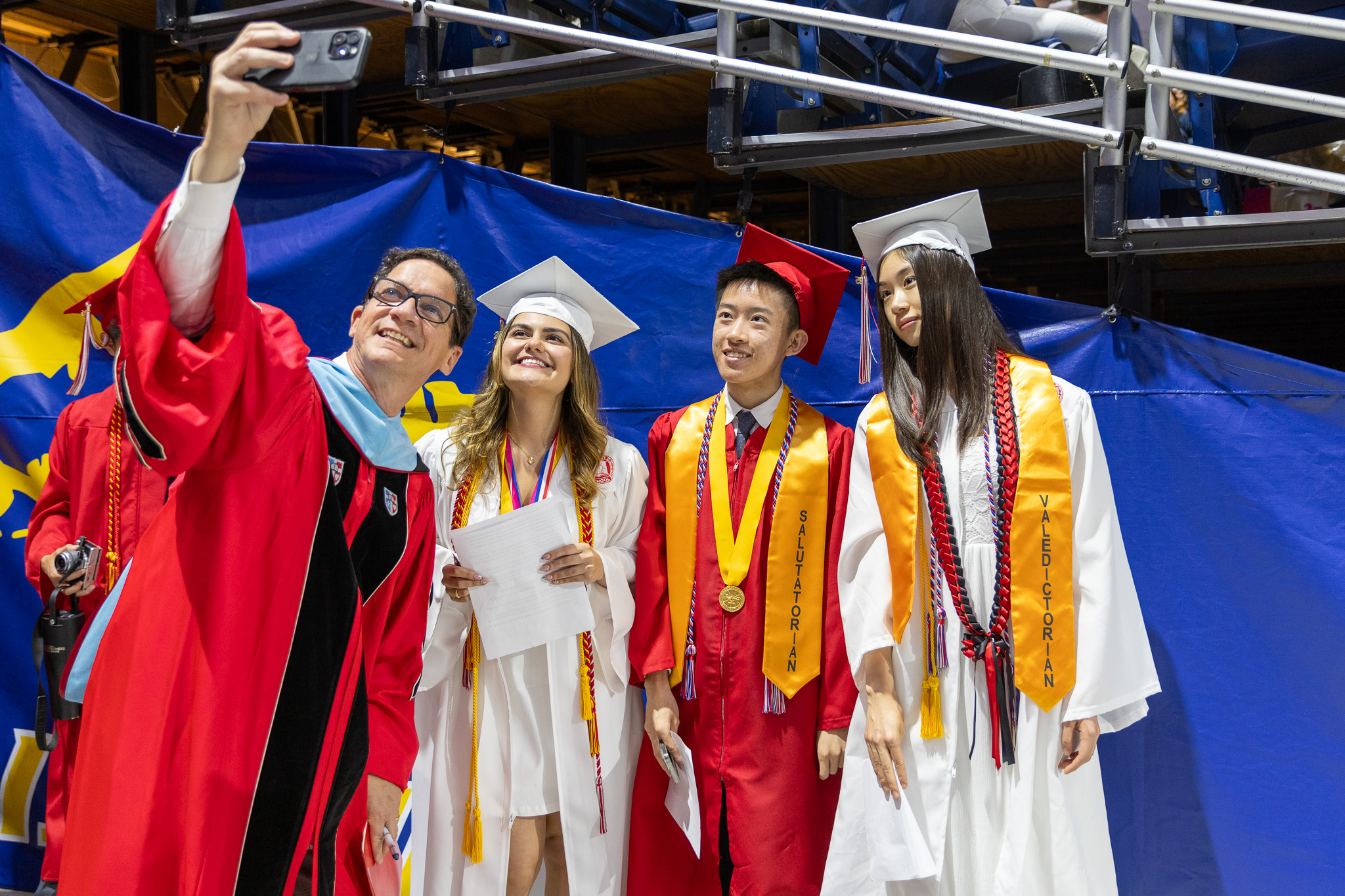 Syosset High School principal Giovanni Durante takes selfie with graduates.