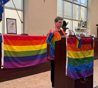 Glen Cove Council Member Marsha Silverman addresses dozens at city hall for the seventh annual Pride flag celebration.
