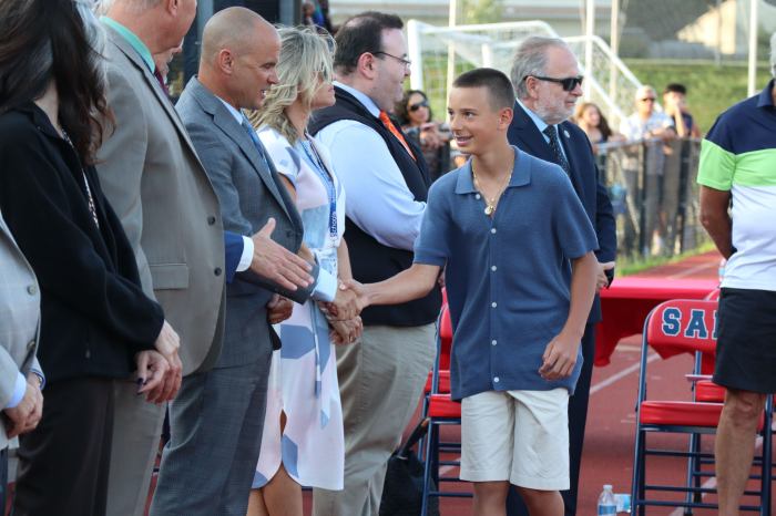 Graduates, now high schoolers, shook hands with trustees and administrators.