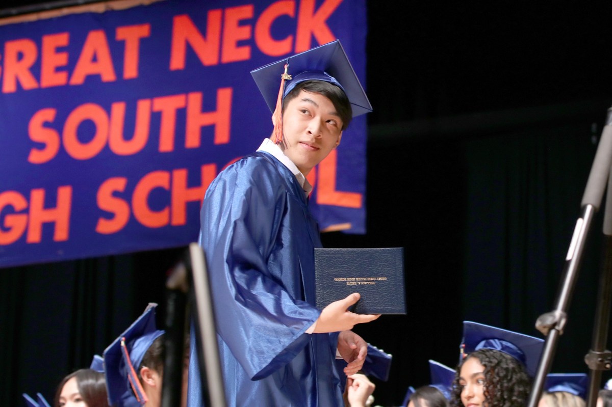 A Great Neck South High School senior walks across the stage after receiving his diploma.