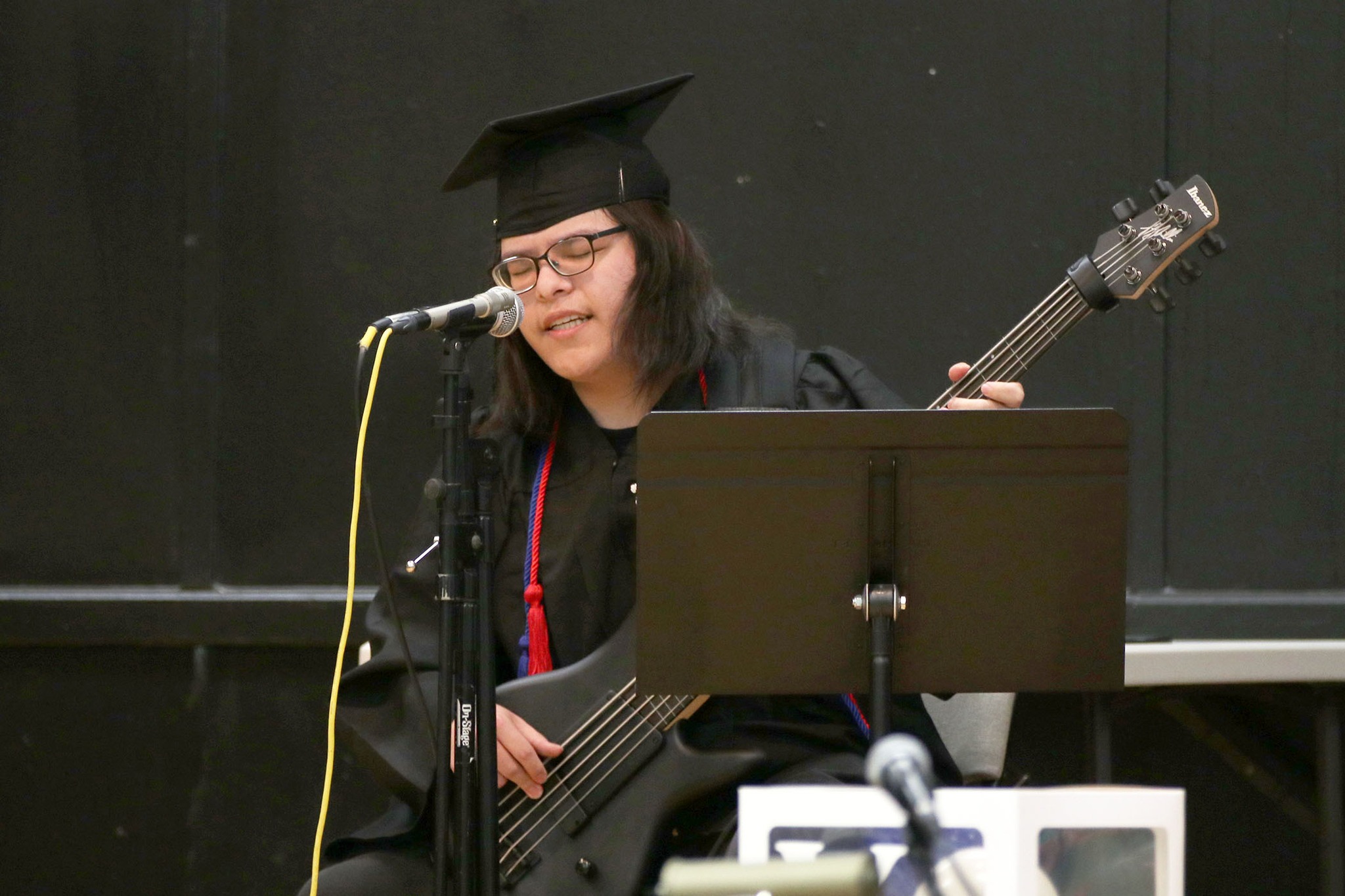 A student plays the bass during a performance at the Village School graduation.
