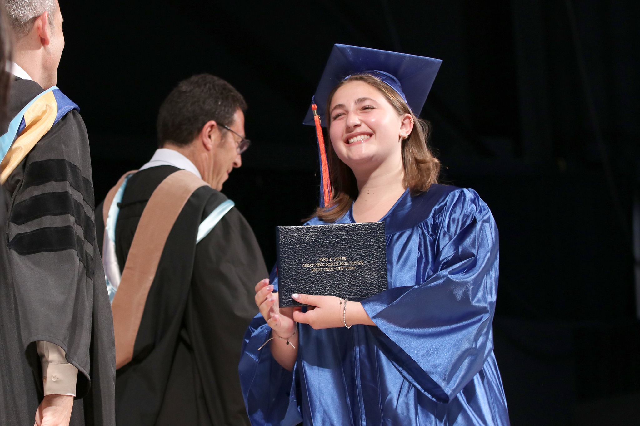 A Great Neck North High School student walks across the stage to receive her diploma.