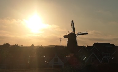 Watching the sun set behind the historic windmill that is the centerpiece of the Museum Kaap Skil in Oudeschild on the island of Texel from the top deck of our ship, Leafde fan Fryslân on Boat Bike Tours’Islandhopping trip © Karen Rubin/goingplacesfarandnear.com