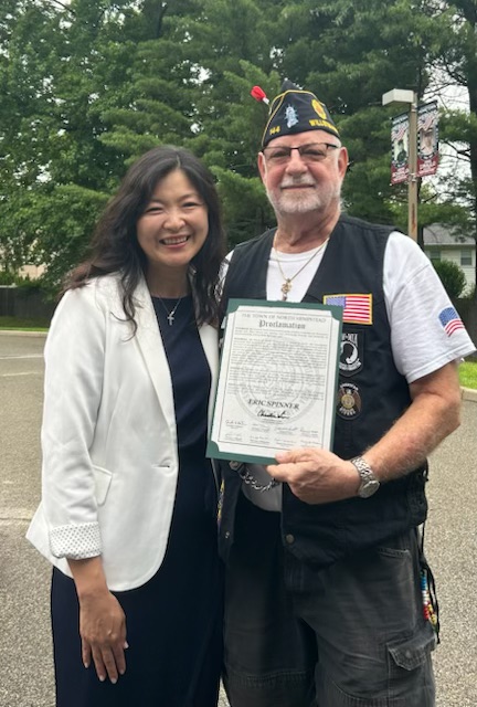Town Councilwoman Christine Liu and veteran Eric Spinner with his proclamation.