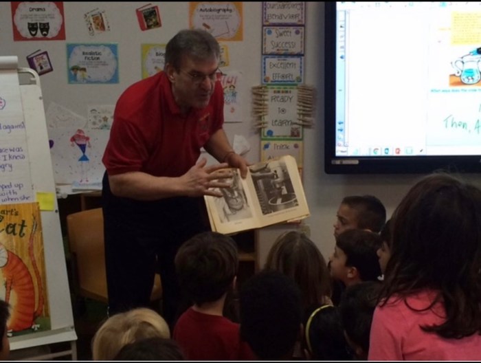 Don Bekteshi reading to a group of students.