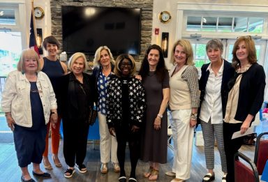 Members of the Glen Cove Rotary Club, including President Toya Davis (C.) and city Mayor Pam Panzenbeck (C. L.)