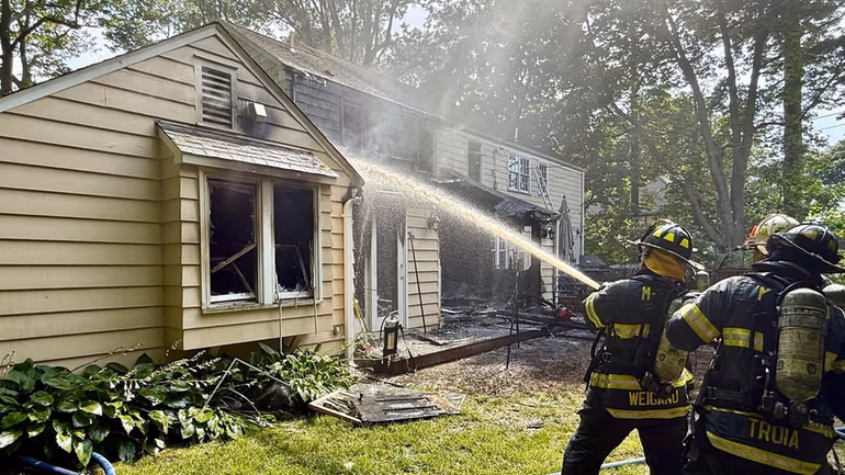Firefighters responding to the house fire in Thomaston