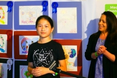 1st Place winner, Jilian Zhang, for the 3 - 5 Grade Category. Lisa Herlihy representing the Champskids program offers applause to the right.